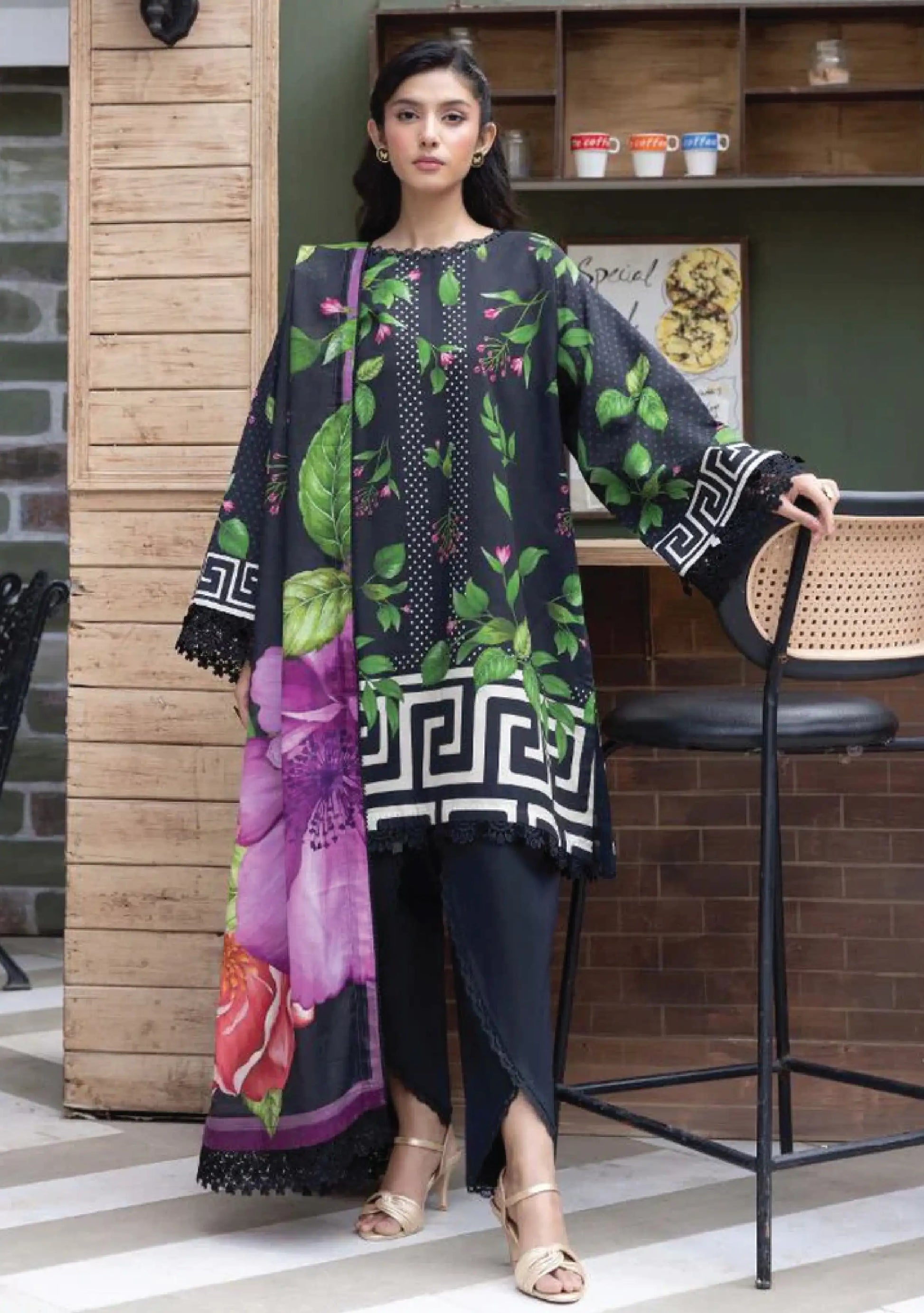 Full-length front studio look of M Basic by Elaheh Volume 4 unstitched collection code MB-ELHV4-03 black casual lawn suit with bold green print layout.