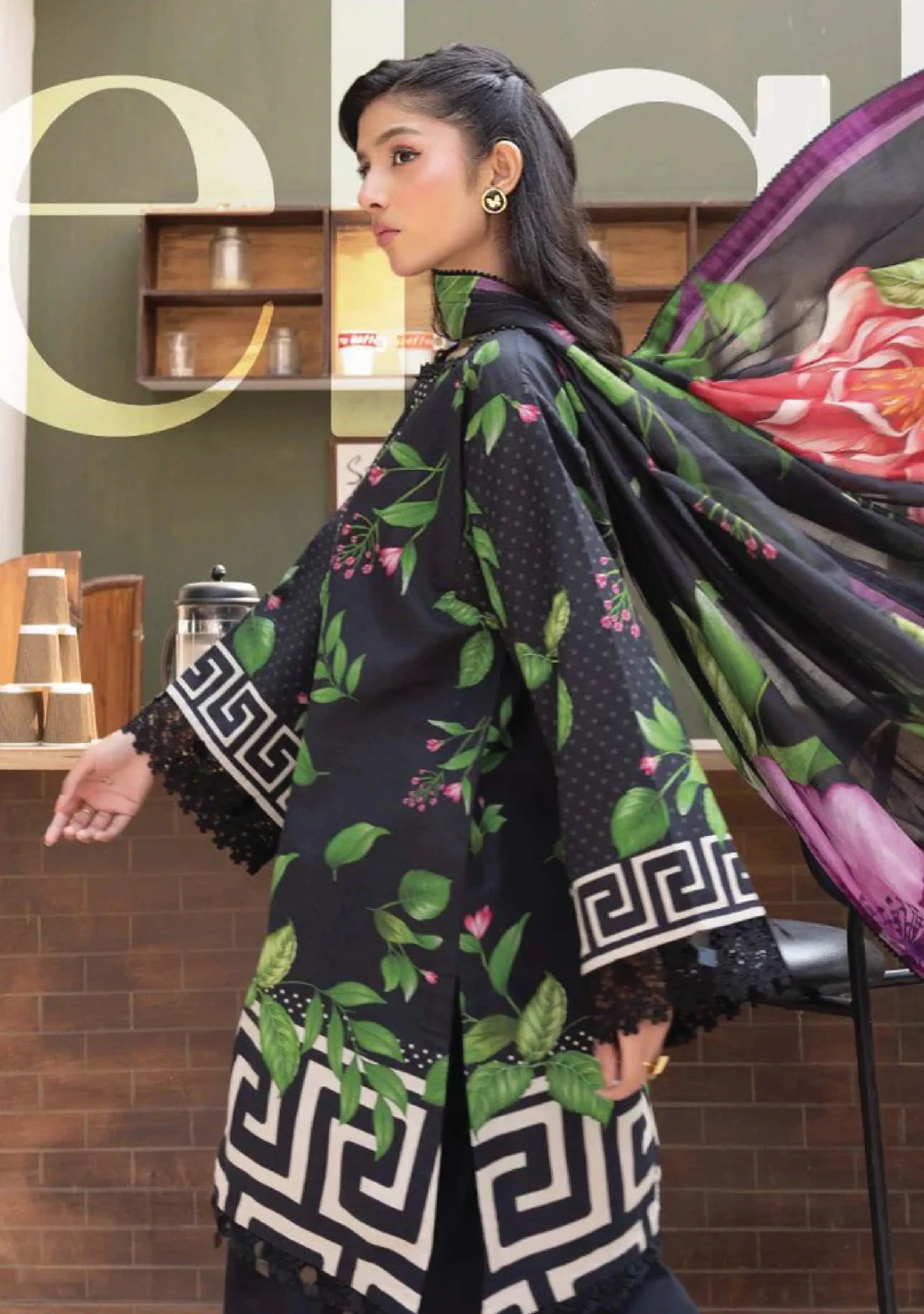 Side profile movement shot showing the large purple and pink floral prints on the black voile dupatta code MB-ELHV4-03.