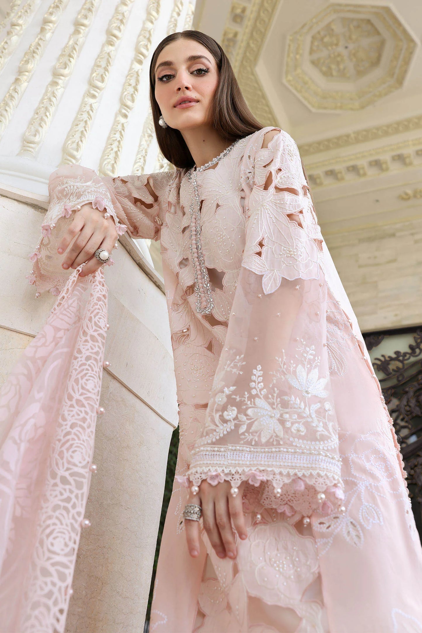Detailed perspective view focusing on the embroidered lawn sleeves cutouts and pearl hanging trims along the shirt hem cuff code D2.