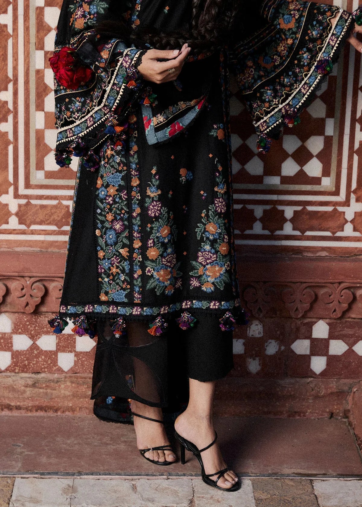 Focus view of the embroidered daman border patterns and panel finishing details on the black lawn shirt material.