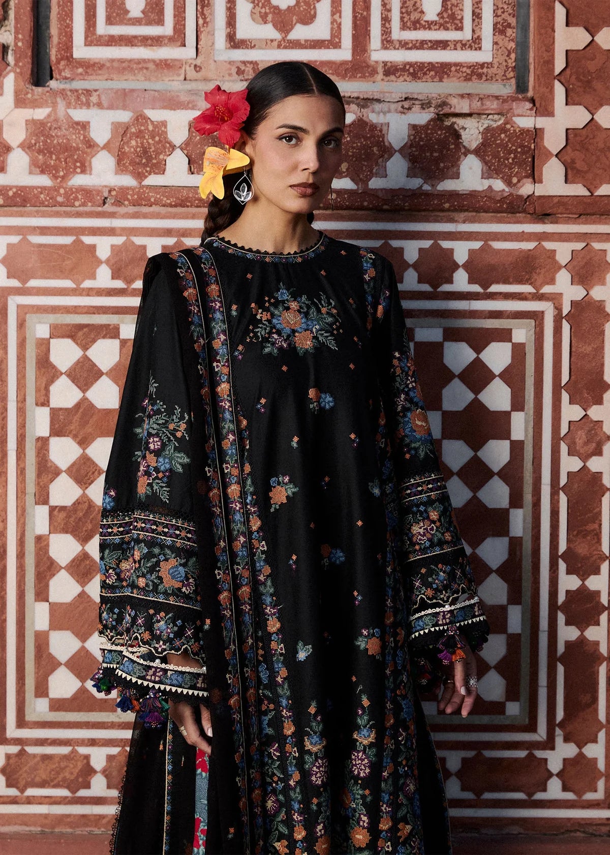 Close-up portrait view of the premium multi-color cross-stitch neckline and sleeve embroidery detail on Aswa design.