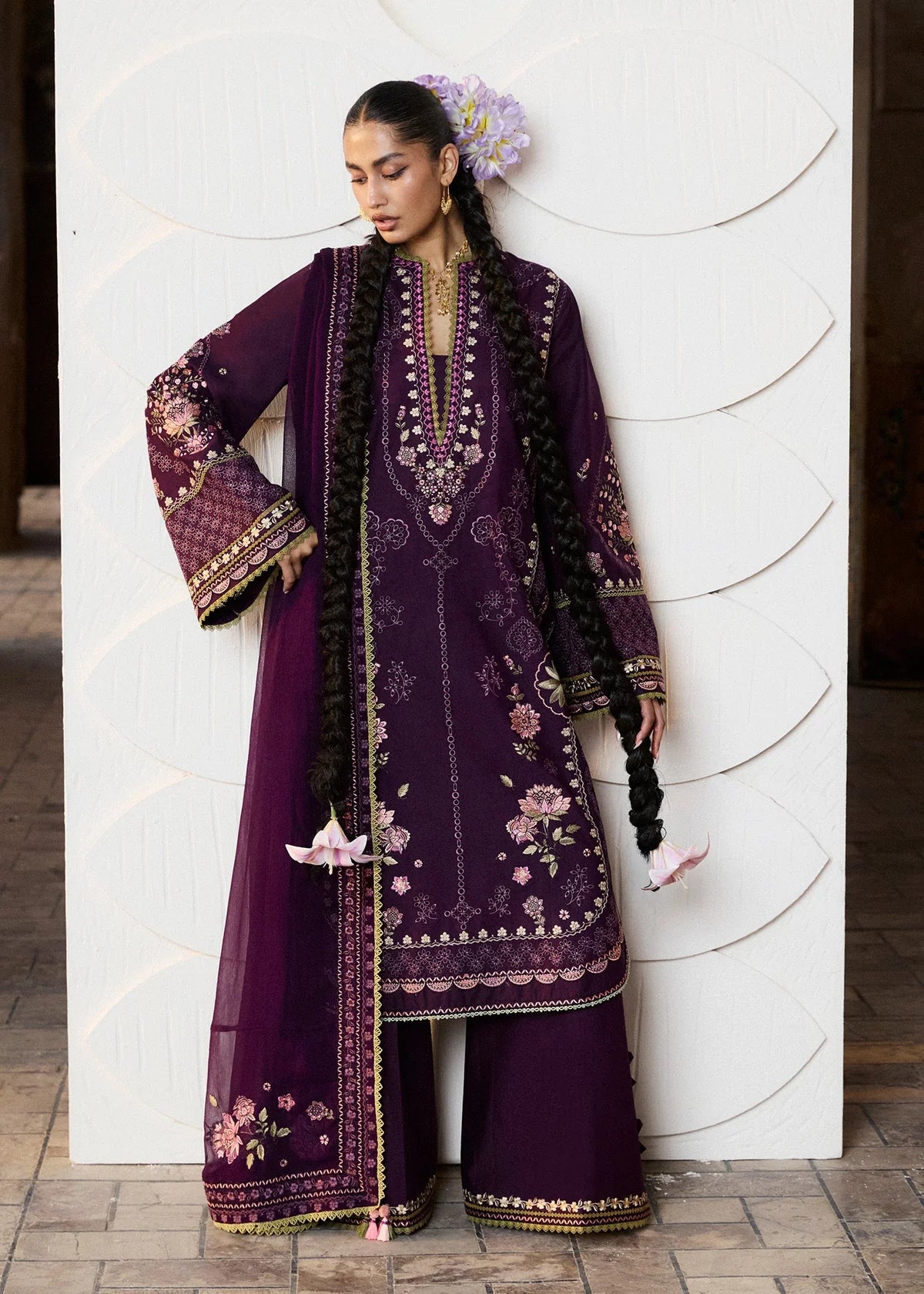 Close-up front portrait focusing on the rich light green and pink neckline threadwork embroidery and broad decorative panel bands across the sleeves.