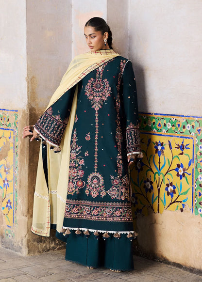 Model standing profile view showcasing the contrast yellow chiffon dupatta drape paired with the long zinc embroidered shirt.
