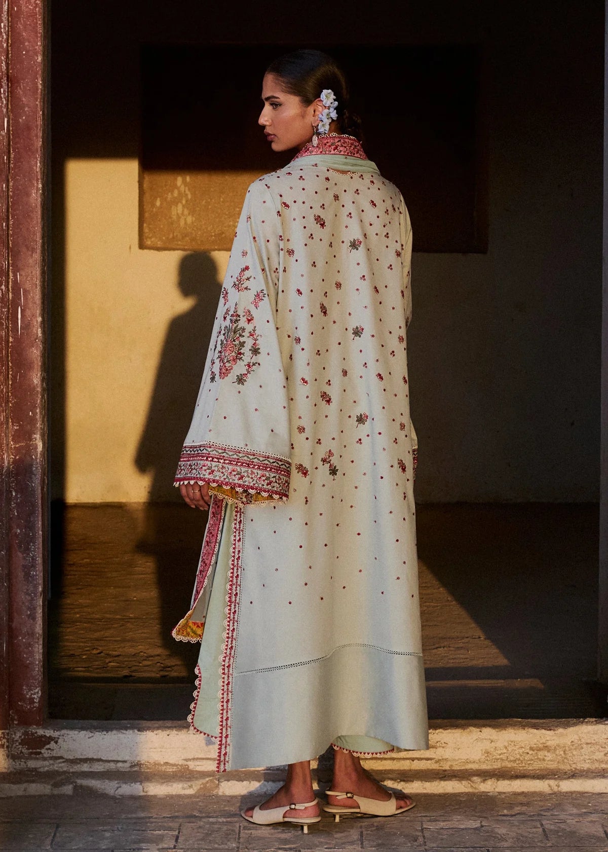 Rear model view showcasing the subtle all-over embroidered spray patterns across the back panel and textured dobby fabric profile.