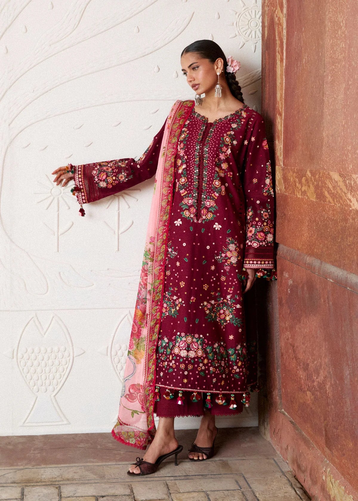 Front profile pose showing the expansive sleeve embroidery detail and attached lace parameters on maroon fabric.