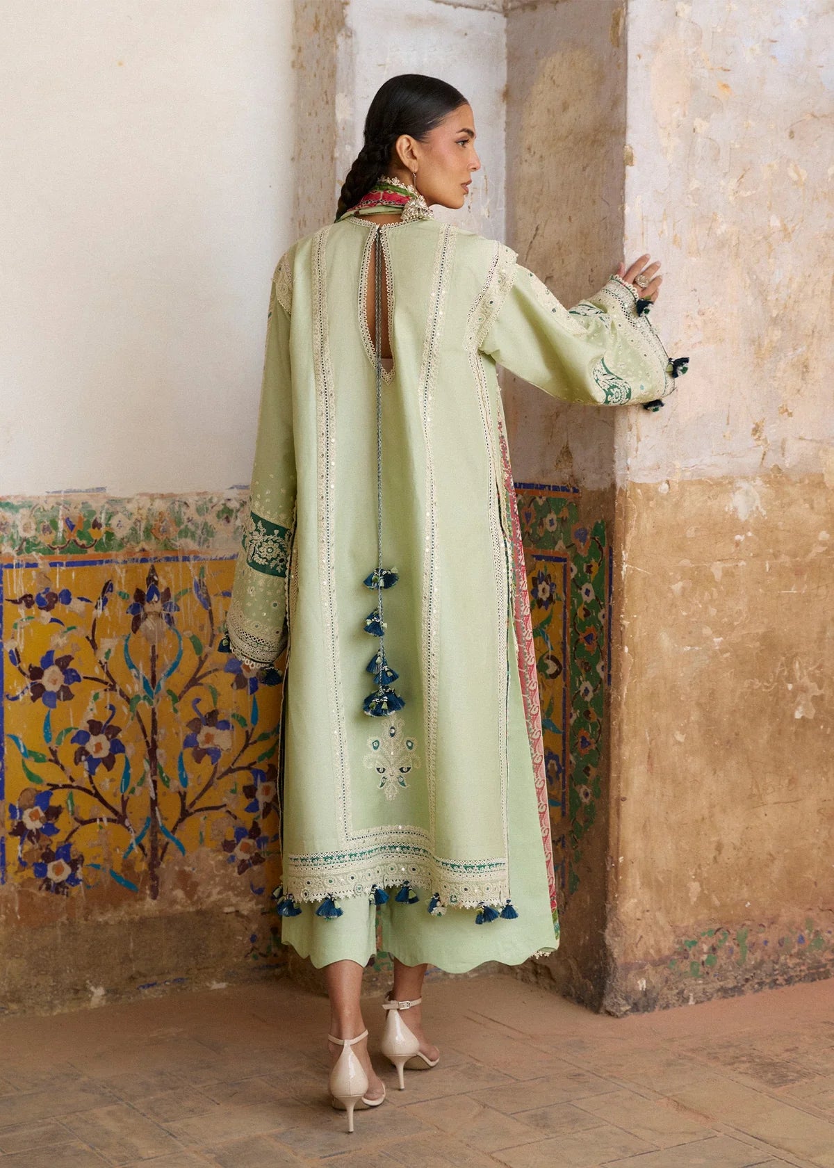 Rear model view showcasing the structural back panels, keyhole neckline closure design, and lace trims of the mint green shirt.