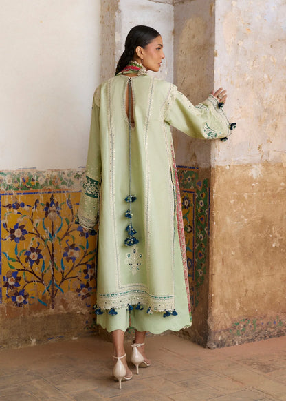 Rear model view showcasing the structural back panels, keyhole neckline closure design, and lace trims of the mint green shirt.