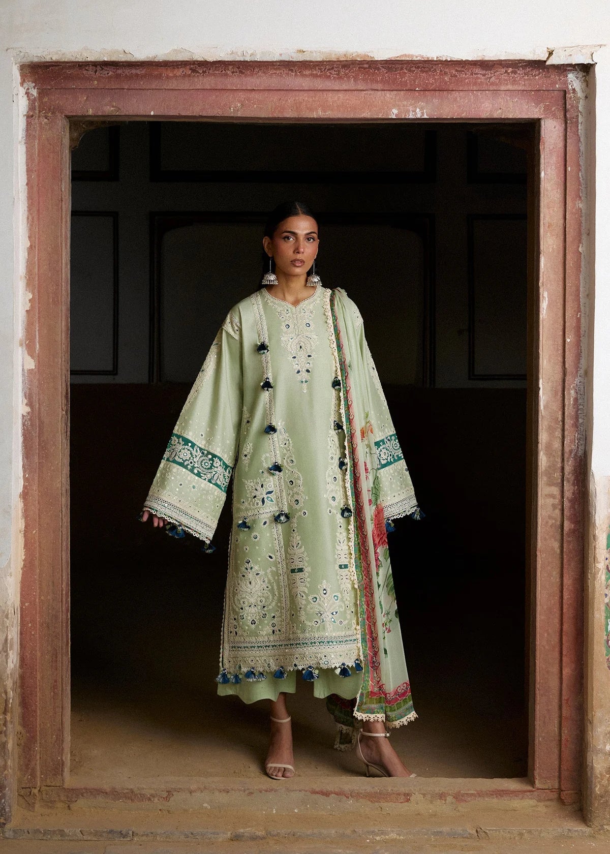 Wide front studio shot focusing on the panel layouts, sleeve embroidery edges, and sheer geometric hem lace detailing.