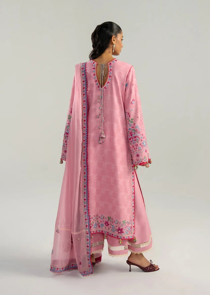 Rear model view showcasing the structural back panels, keyhole tassel ties, and delicate pink embroidery parameters on the hemline.