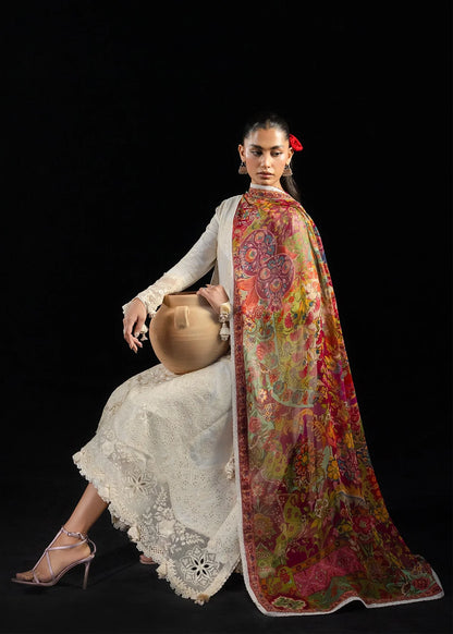 Full sitting presentation focusing on the contrast balance between the white embroidery shirt and the bright festive dupatta layout.