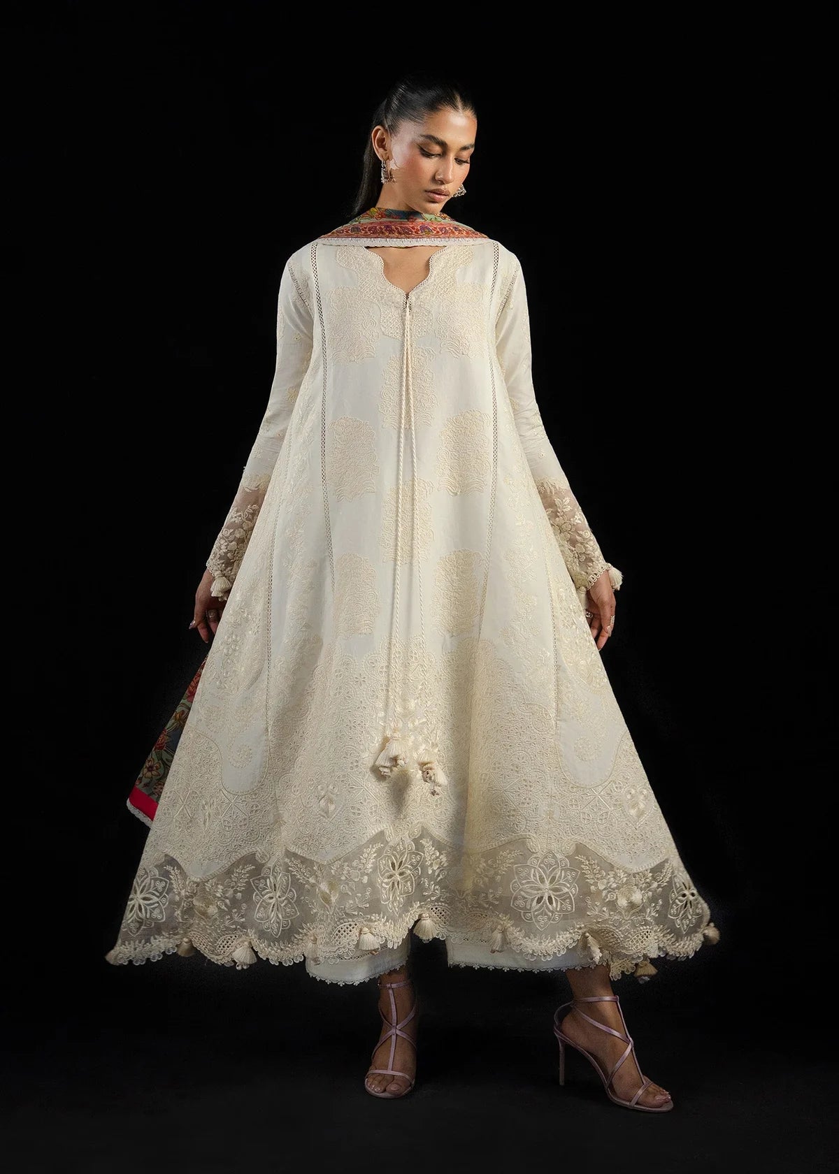 Wide model shot displaying the continuous self-embroidery panels and sheer detailed organza daman hemline borders.