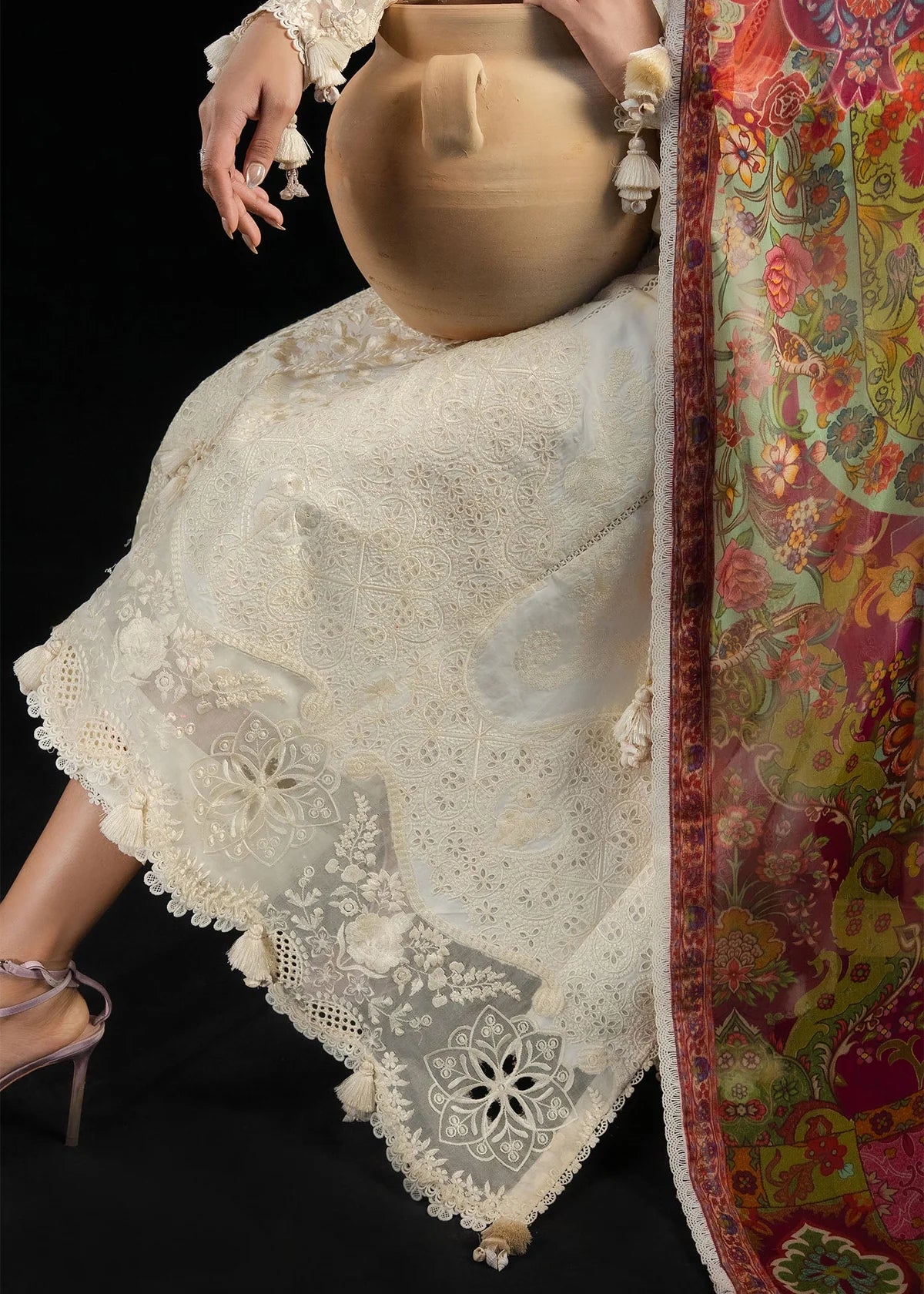 Detailed close-up macro view of the intricate floral-patterned sheer organza border attached to the shirt bottom.