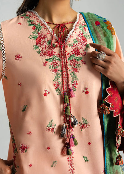 High-fidelity close-up portrait focusing on the detailed red and pink floral neckline embroidery and tasseled neck strings.